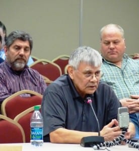 Subsistence Regional Advisory Council Chairman Bert Adams presents recommendations as Kootznoowoo's Peter Naoroz, left, and seiner Bob Thorstenson, right, listen. Photo by Ed Schoenfeld.