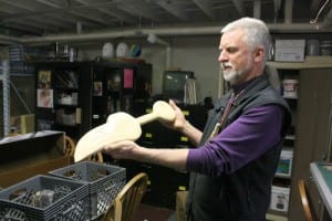 Charlie Bean holds a spoon carved in the basement where he led clients through art projects, at the Bill Brady Healing Center. Tuesday was the center's last day of operation.
