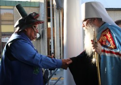 Native elders greets Metroplitan Tikhon on the steps of St. Michael's Cathedral. (KCAW photo/by Emily Forman)