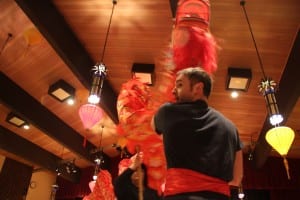 The Mayo family performs a traditional dragon dance for Chinese New Year. (KCAW photo/Emily Forman)
