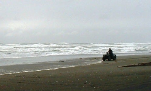 An ATV’er rides along a Yakutat beach where a wave-energy system is to be installed. A Boston-based company will try out the first device in 2015. (Ed Schoenfeld/CoastAlaska News)