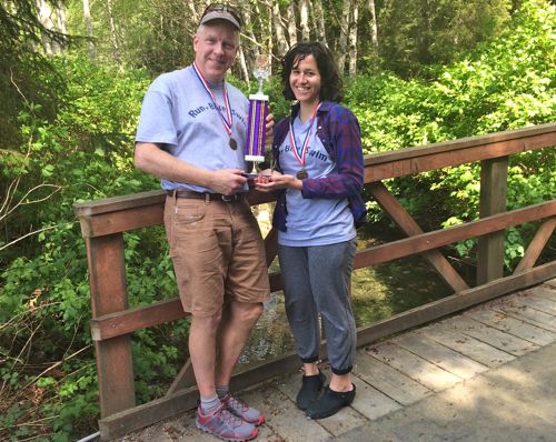 KCAW news director Robert Woolsey and news fellow Emily Forman strain under the weight of their championship trophy. (KCAW photo/Rachel Waldholz)