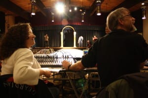 Chelsey Wheeler and Peter Apathy confer with an artist about music during dress rehearsal at Sitka's Wearable Arts Show. (Photo by Ed Ronco/KCAW)