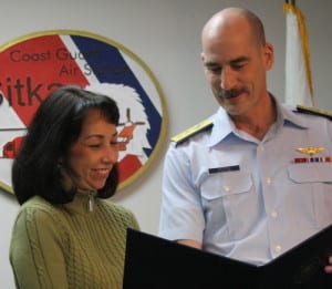 Rose MacIntyre receives an award from Rear Adm. Thomas Ostebo. MacIntyre was instrumental in forming the Sitka Coast Guard Spouses and Women's Association. (KCAW photo by Ed Ronco)