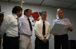 From left, Tyler Orbison, Gerald Gangle and Don Kluting receive a public service award from Coast Guard Rear Adm. Thomas Ostebo. The Sitka Mountain Rescue team members participated in a rescue in Nakwasina Sound in early 2012.