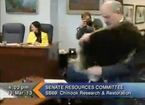 Bert Stedman carries a sea otter pelt before explaining his bill to the Senate Resources Committee on Wednesday.