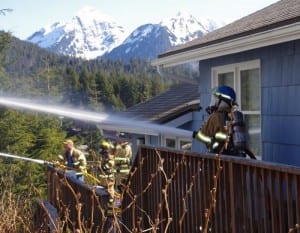 Firefighters used the decks of neighboring homes to attack the fire from different angles. It took more than two hours to extinguish. (Photo by Roberta White/Sitka Fire Department)