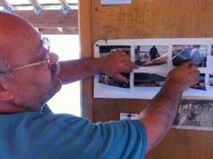 Sitka Salmon Derby Barge Chairman John McCrehin shows photos of the barge being built in 2004. The derby is in its 58th year, and McCrehin has run the main weigh-in barge for the last seven or eight years. He's been with the derby for about 15. (KCAW photo by Ed Ronco)