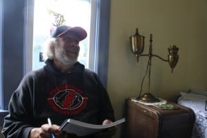 Mike Stempe signs copies of a book he co-authored with Tom Paul and Mark Kirchhoff. (KCAW photo by Ed Ronco)