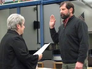 Municipal attorney Robin Koutchak administers the oath of office to Lon Garrison, who won a third term last month. His colleagues elected him board president again; Jen Robinson was named vice-chair. (KCAW photo/Robert Woolsey)