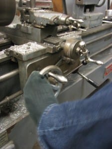 Having limited use of his hands, Partido operates the lathe with his toes. (KCAW photo/Robert Woolsey)