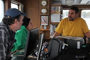 On board the R/V Kestrel, Dave Gordon (right) talks to other ADF&G biologists who have flown in from around Southeast to help manage the herring fishery. (KCAW photo/Rachel Waldholz)