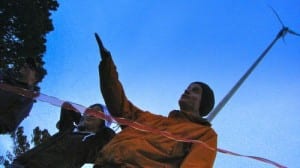Mt. Edgecumbe science teacher Matt Hunter cuts the ribbon on the school's full-size turbine in 2010. (KCAW photo/Robert Woolsey)