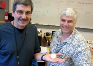 Pat Kraft and John Neibergall. Kraft is holding a geodesic sphere -- with seven concentric geodesic spheres inside it. "There's no conventional tool that can make this," he says. (KCAW photo/Robert Woolsey)