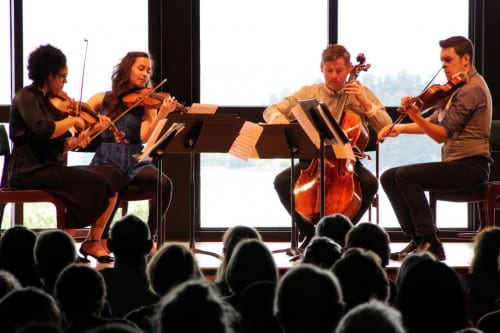 The Catalyst Quartet plays their arrangement of Bach's Goldberg Variations at Sitka's Harrigan Centennial Hall. From left: Jessie Montgomery, Karla Donehew-Perez, Karlos Rodriguez, and Paul Laraia. (Rachel Waldholz / KCAW)
