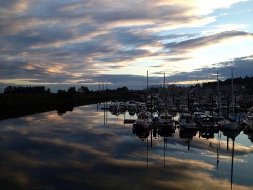 A July sunset from the Sea Walk "spur" on Crescent Harbor. The city's insurer requires a guardrail to be built here. (KCAW photo/Shaleece Haas)