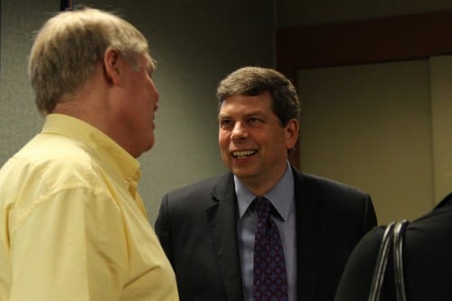 U.S. Senator Mark Begich speaks to Sitka resident Dirk White at the Sitka Chamber of Commerce. (KCAW photo/Rachel Waldholz)