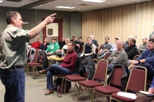 Permit-holders listen to ADF&G biologist Dave Gordon lay out how the 2015 herring fishery will work. This year's fishery is being conducted as a co-op, so far fewer fishermen are in town. (Rachel Waldholz/KCAW)