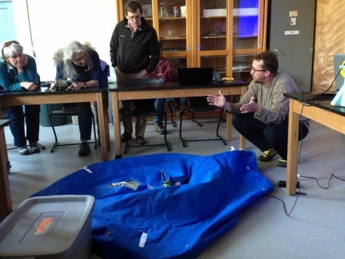 Ian Davidson, from the Smithsonian Environmental Research Center, explains how the canvas enclosure will kill D.vex. The eradication testing is being led by ADF&G biologist Tammy Davis. Tim Sundlov is coordinating the participation of the Bureau of Land Management, which controls the intertidal areas. Other members of the Smithsonian team diving in Sitka are Michelle Marraffini and Greg Ruiz.