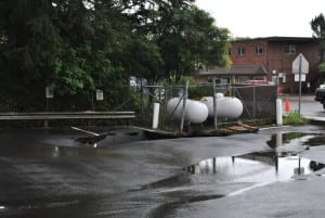 A sinkhole had opened up beneath a pair of propane tanks on Halibut Point Road. (Rebecca LaGuire, KCAW)