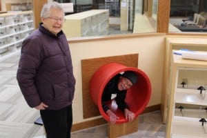 Bill Foster demonstrates a special feature of the children's room -- as only he can. (KCAW photo/Robert Woolsey)