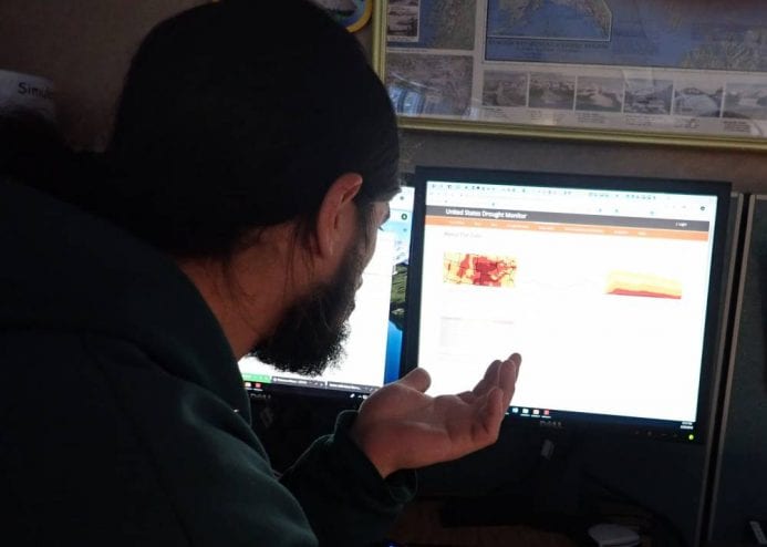 Federal hydrologist Aaron Jacobs at the National Weather Service’s Juneau office says traditional drought indicators don’t always apply to Southeast Alaska’s temperate rainforest. (Photo by Jacob Resneck/CoastAlaska)